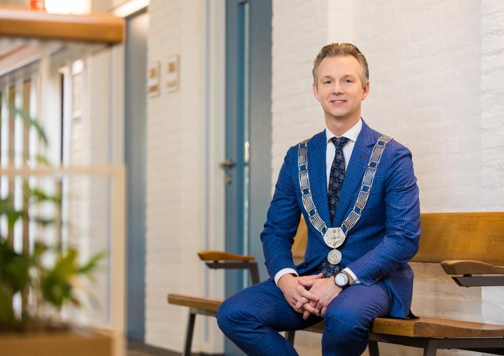Burgemeester Gido Oude Kotte op bank in raadhuis