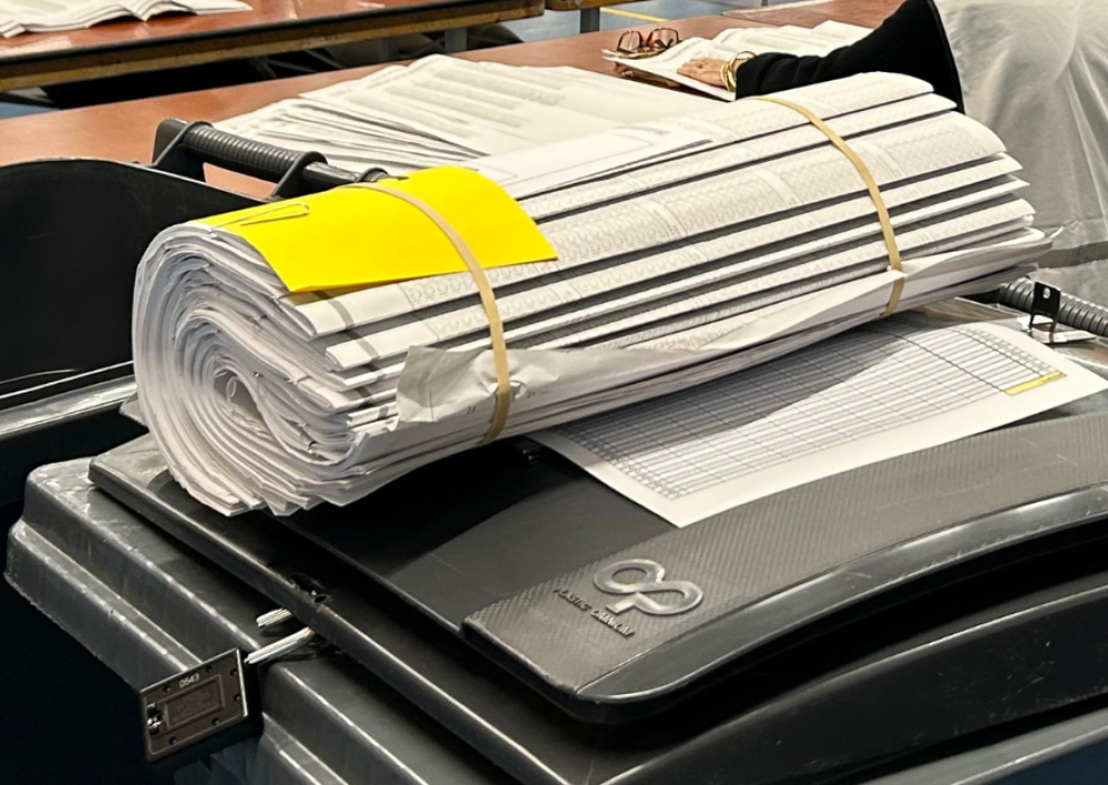 Stembiljetten opgerold op een stembus tijdens het tellen van de stemmen